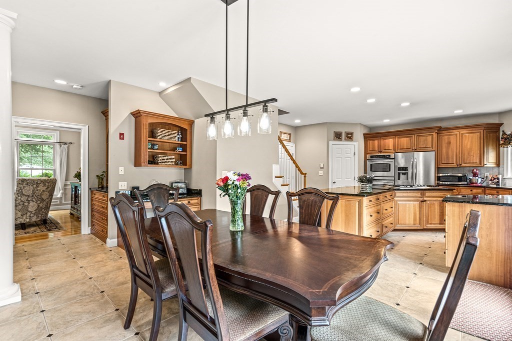 11 Pondview Lane Reading, MA 01867 - Photo 11 of 42 a dining room with furniture and wooden floor
