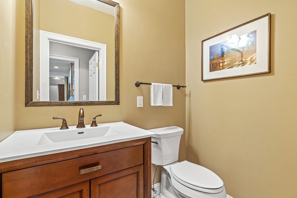 11 Pondview Lane Reading, MA 01867 - Photo 19 of 42 a bathroom with a toilet sink and mirror
