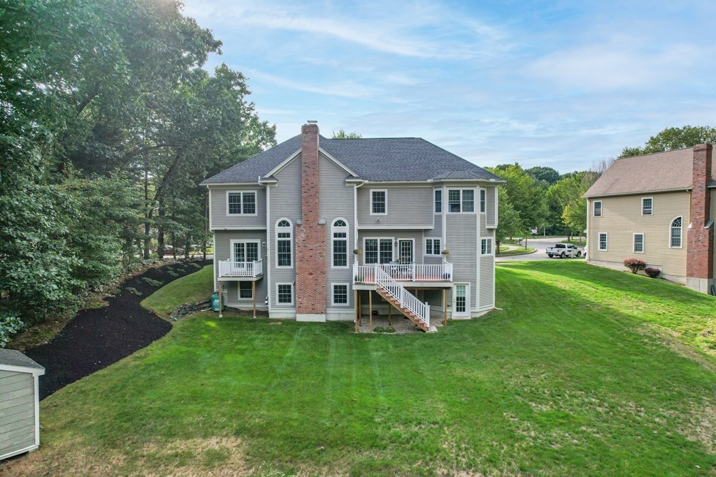 11 Pondview Lane Reading, MA 01867 - Photo 2 of 42 a view of a house with a yard and sitting area