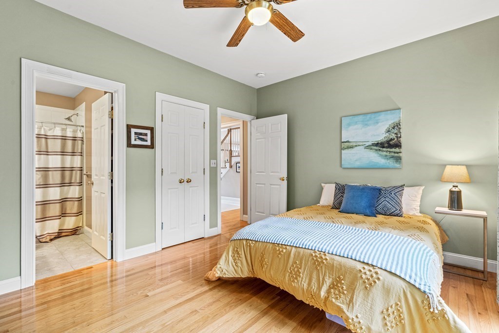 11 Pondview Lane Reading, MA 01867 - Photo 21 of 42 a bedroom with a bed and wooden floor