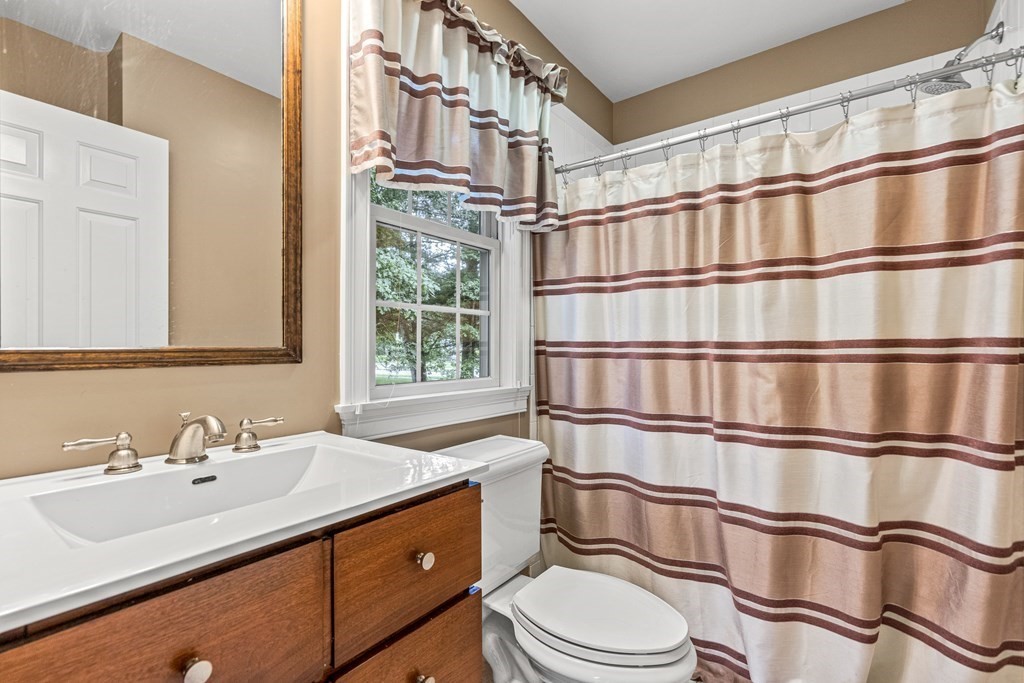 11 Pondview Lane Reading, MA 01867 - Photo 22 of 42 a bathroom with a sink a toilet and shower