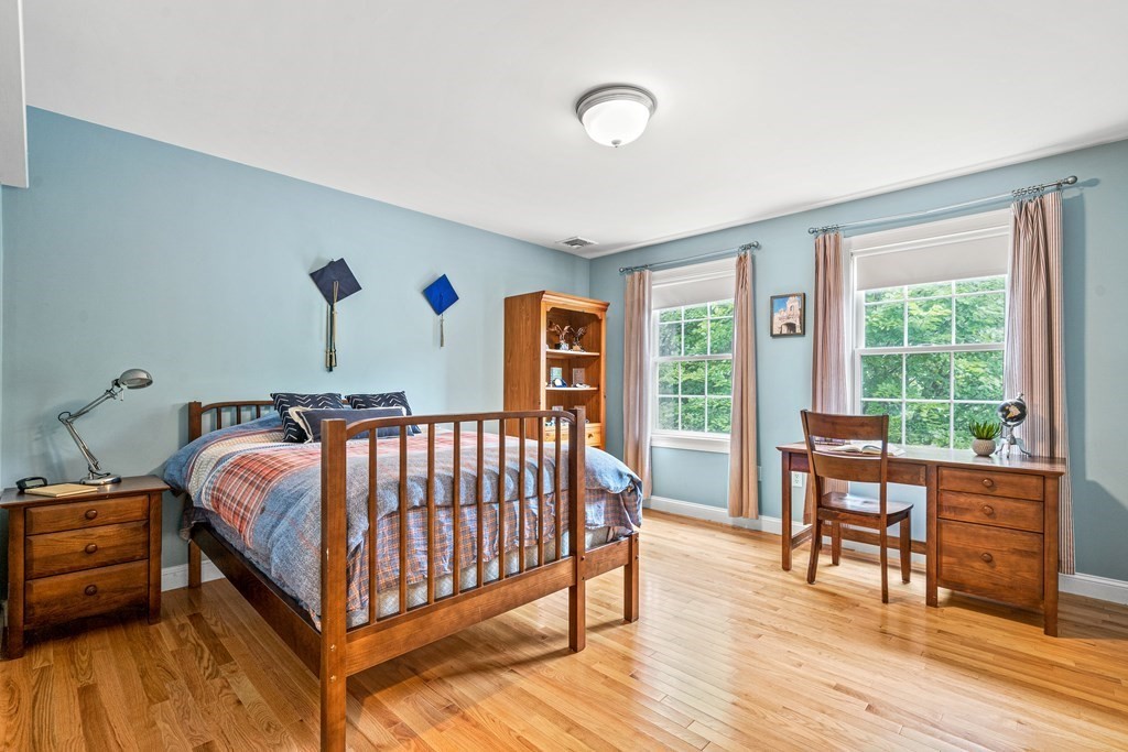11 Pondview Lane Reading, MA 01867 - Photo 33 of 42 a bed sitting in a bedroom next to a window