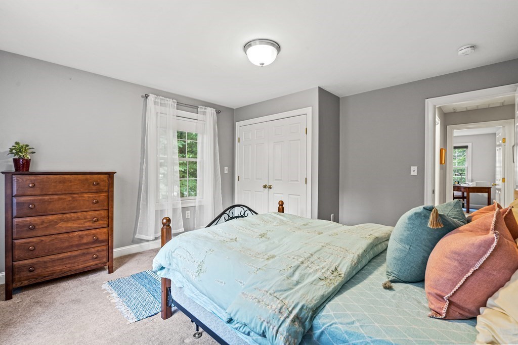 11 Pondview Lane Reading, MA 01867 - Photo 35 of 42 a bedroom with a bed and a dresser