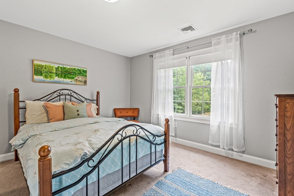 11 Pondview Lane Reading, MA 01867 - Photo 36 of 42 a bedroom with a bed and a window