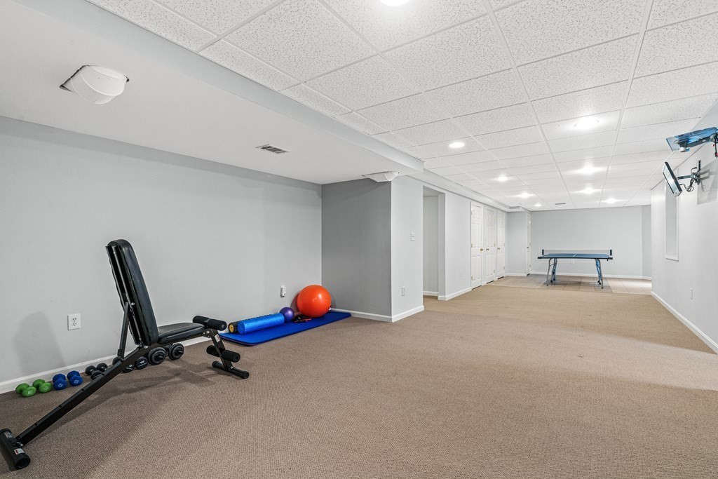 11 Pondview Lane Reading, MA 01867 - Photo 39 of 42 a view of a room with gym equipment