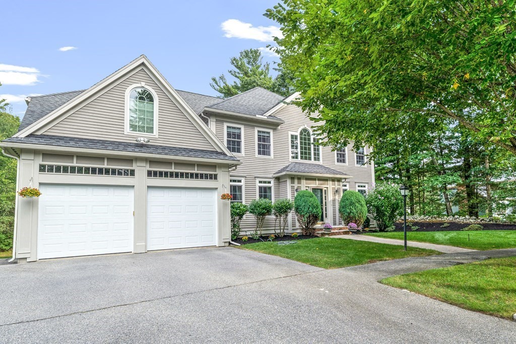 11 Pondview Lane Reading, MA 01867 - Photo 40 of 42 a front view of a house with a yard