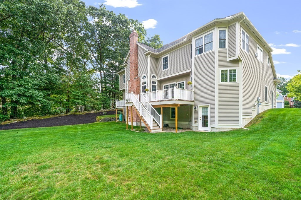 11 Pondview Lane Reading, MA 01867 - Photo 42 of 42 a front view of a house with a yard and trees