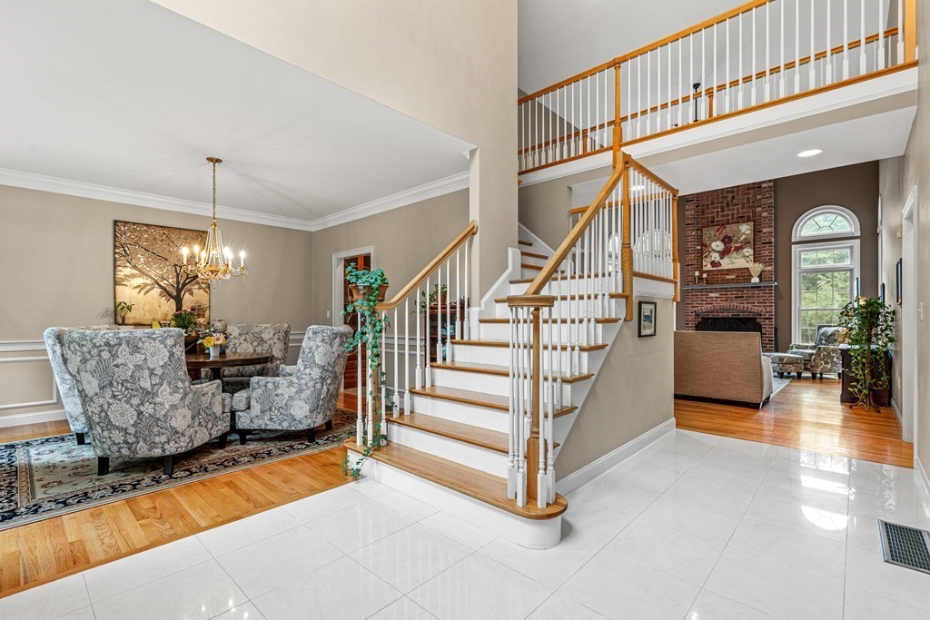11 Pondview Lane Reading, MA 01867 - Photo 6 of 42 a living room with furniture and a chandelier