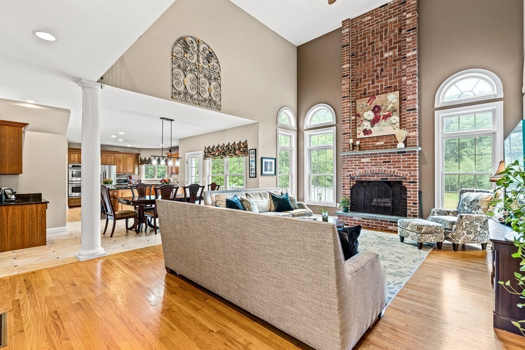 11 Pondview Lane Reading, MA 01867 - Photo 8 of 42 a living room with furniture and a fireplace