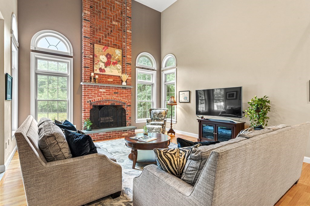 11 Pondview Lane Reading, MA 01867 - Photo 9 of 42 a living room with furniture fireplace and a large window