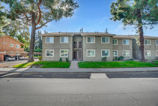 a view of road with a house in the background