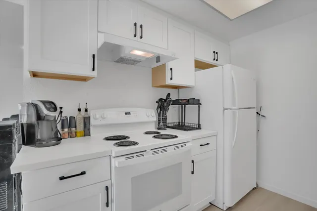 a kitchen with cabinets and appliances