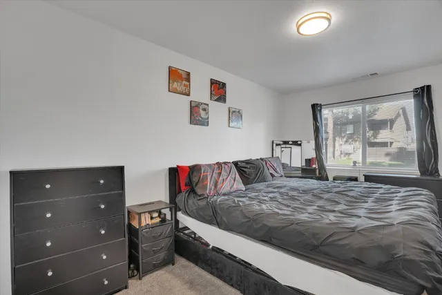 a bedroom with a bed and large window