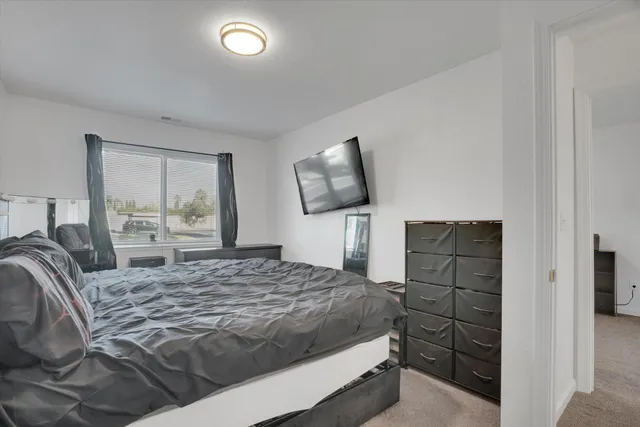 a bedroom with a bed and a television