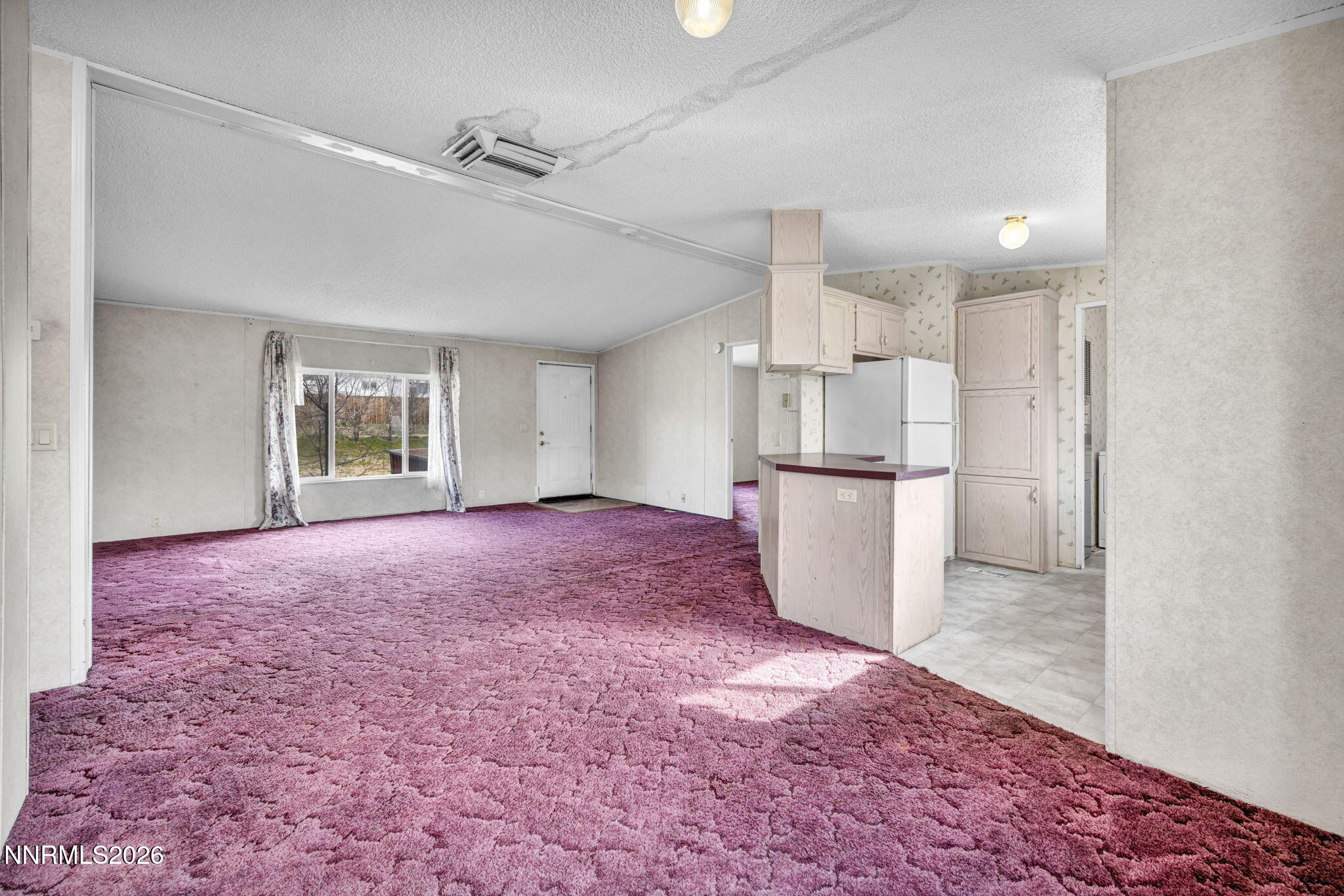 5107 Leon Drive Sun Valley, NV 89433 - Photo 11 of 43 a open kitchen with stainless steel appliances granite countertop a refrigerator and a sink