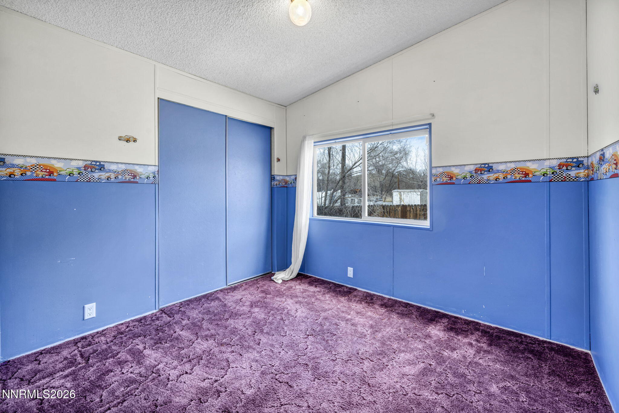 5107 Leon Drive Sun Valley, NV 89433 - Photo 23 of 43 a view of an empty room with window and wooden floor