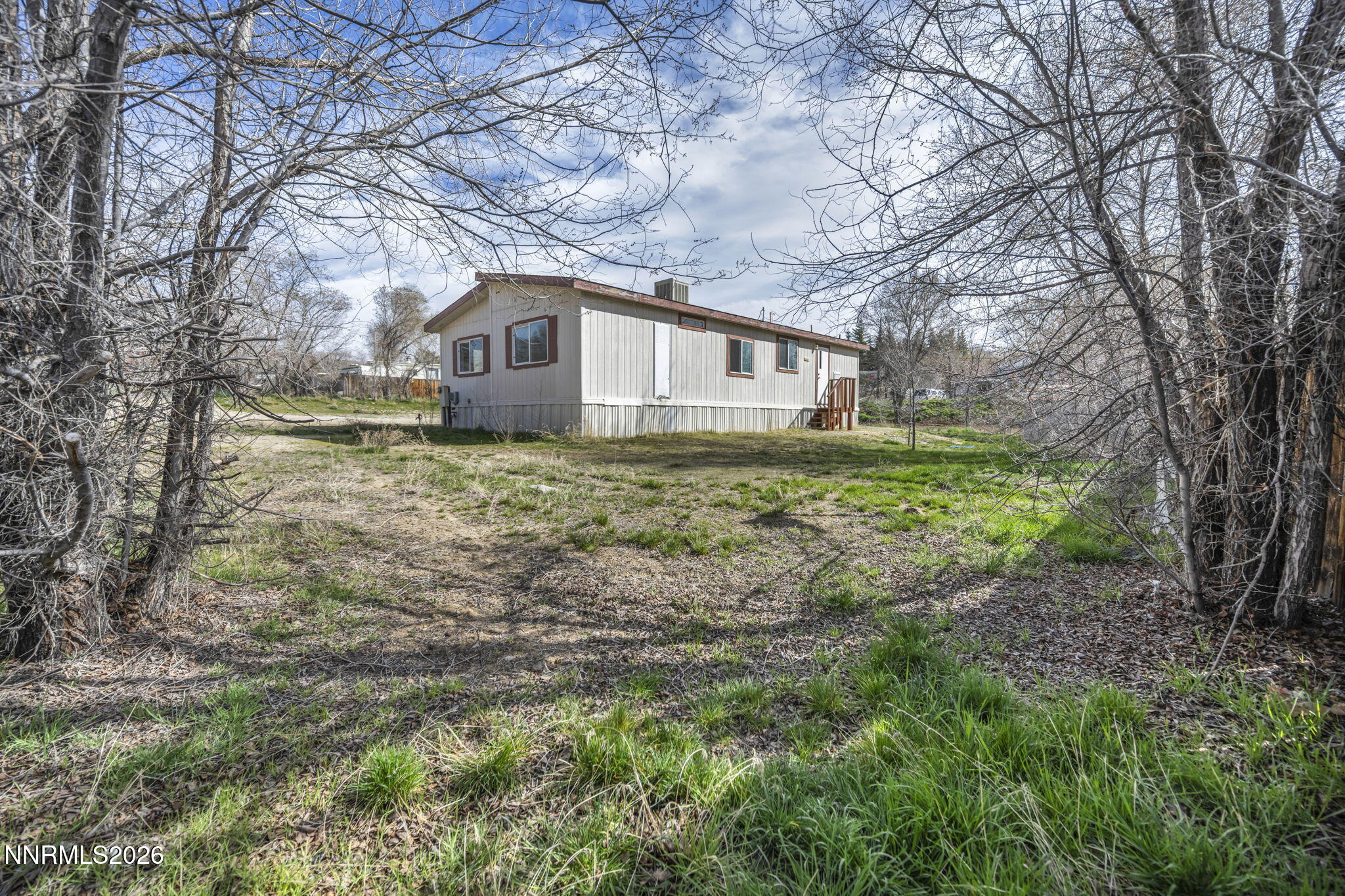 5107 Leon Drive Sun Valley, NV 89433 - Photo 30 of 43 a house is sitting in middle of the forest