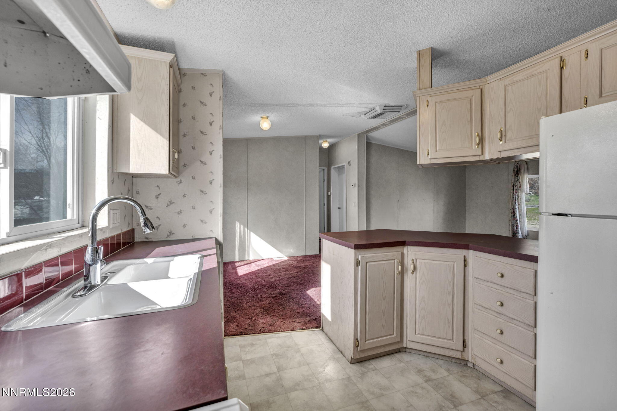 5107 Leon Drive Sun Valley, NV 89433 - Photo 6 of 43 a kitchen with granite countertop a sink a stove and cabinets