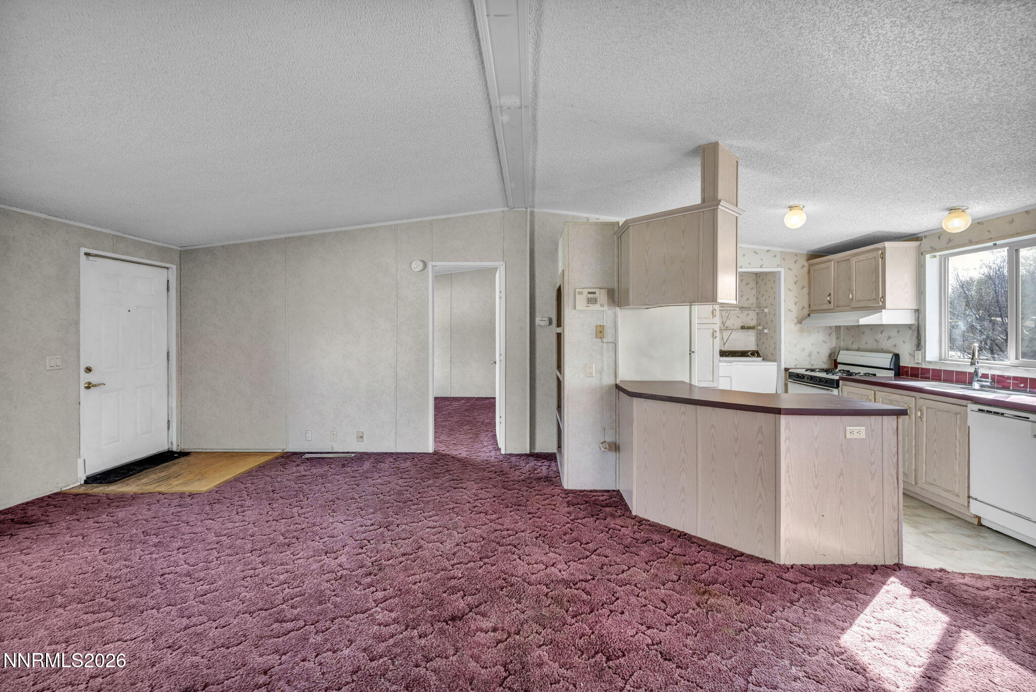 5107 Leon Drive Sun Valley, NV 89433 - Photo 9 of 43 a large kitchen with cabinets and a wooden floor