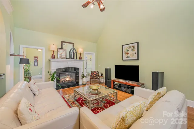 a living room with furniture flat screen tv and a fireplace