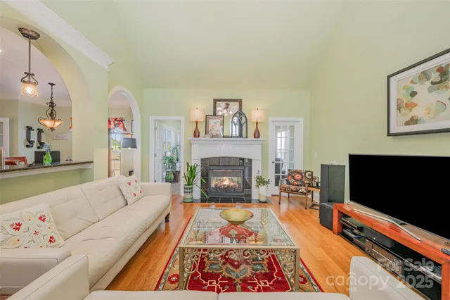 a living room with fireplace furniture and a flat screen tv