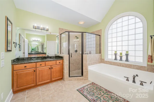 a spacious bathroom with a tub a sink and a large mirror