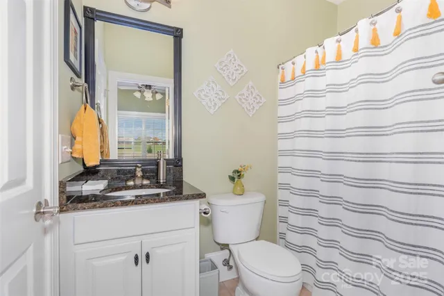 a bathroom with a toilet a sink and a mirror