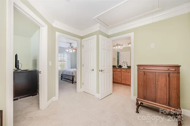 a view of a hallway and a livingroom with furniture