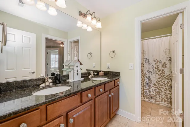 a bathroom with double vanity sinks and a mirror