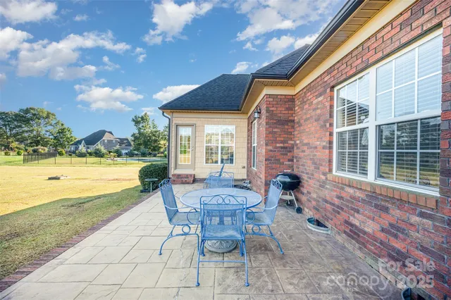 a view of a patio with a table and chairs