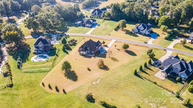 a view of a swimming pool with a yard and sitting area