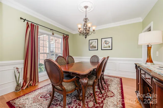 a view of a dining room with furniture and a chandelier