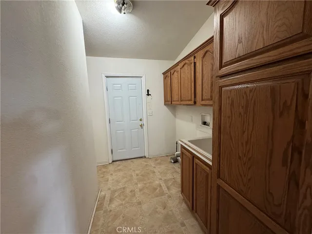 a kitchen with a refrigerator and cabinets
