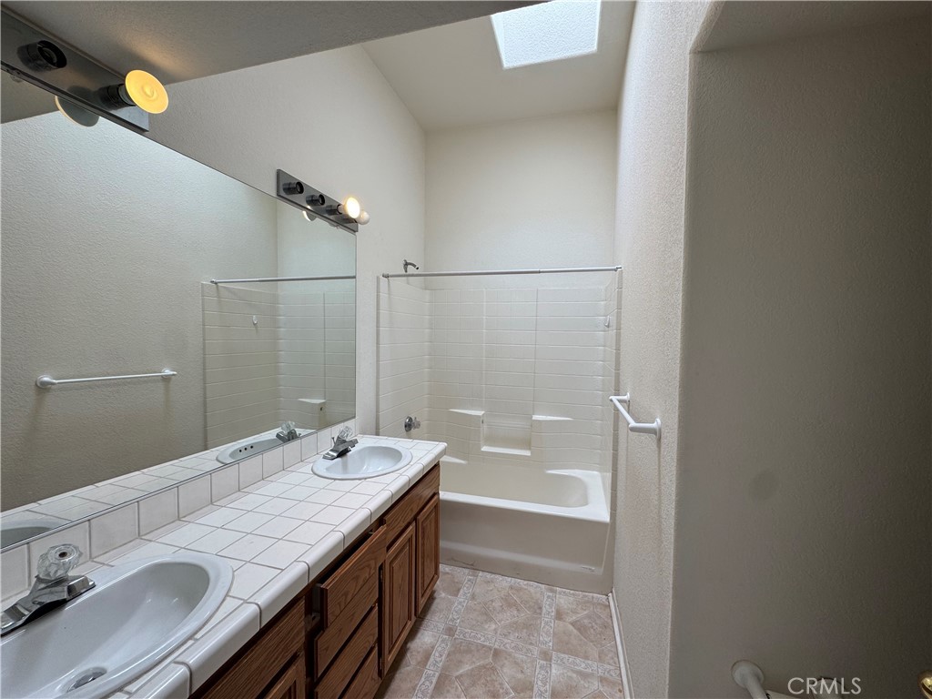 61225 High Country Trail Anza, CA 92539 - Photo 12 of 34 a bathroom with a granite countertop sink a toilet and shower