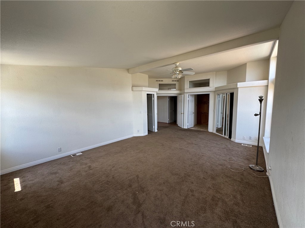 61225 High Country Trail Anza, CA 92539 - Photo 18 of 34 an empty room with a kitchen and refrigerator