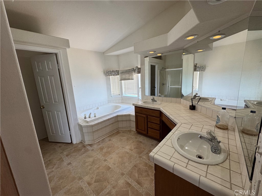 61225 High Country Trail Anza, CA 92539 - Photo 21 of 34 a bathroom with a tub sink and mirror
