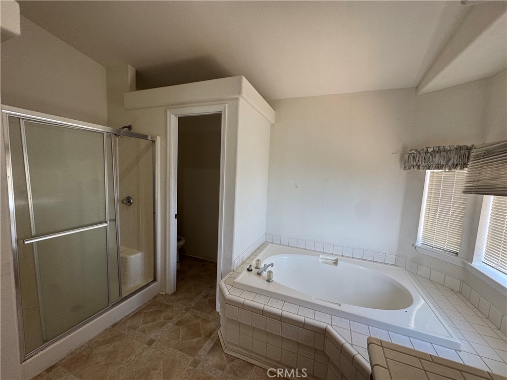 61225 High Country Trail Anza, CA 92539 - Photo 23 of 34 a bathroom with a tub and shower