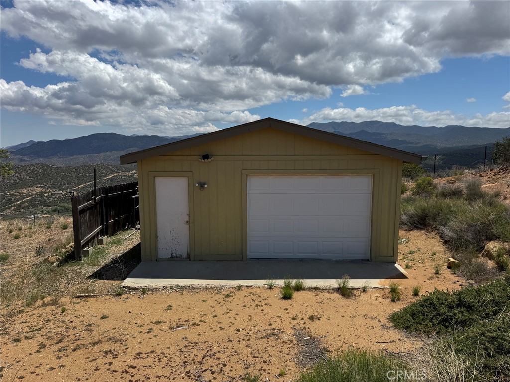 61225 High Country Trail Anza, CA 92539 - Photo 25 of 34 a front view of a house with a yard
