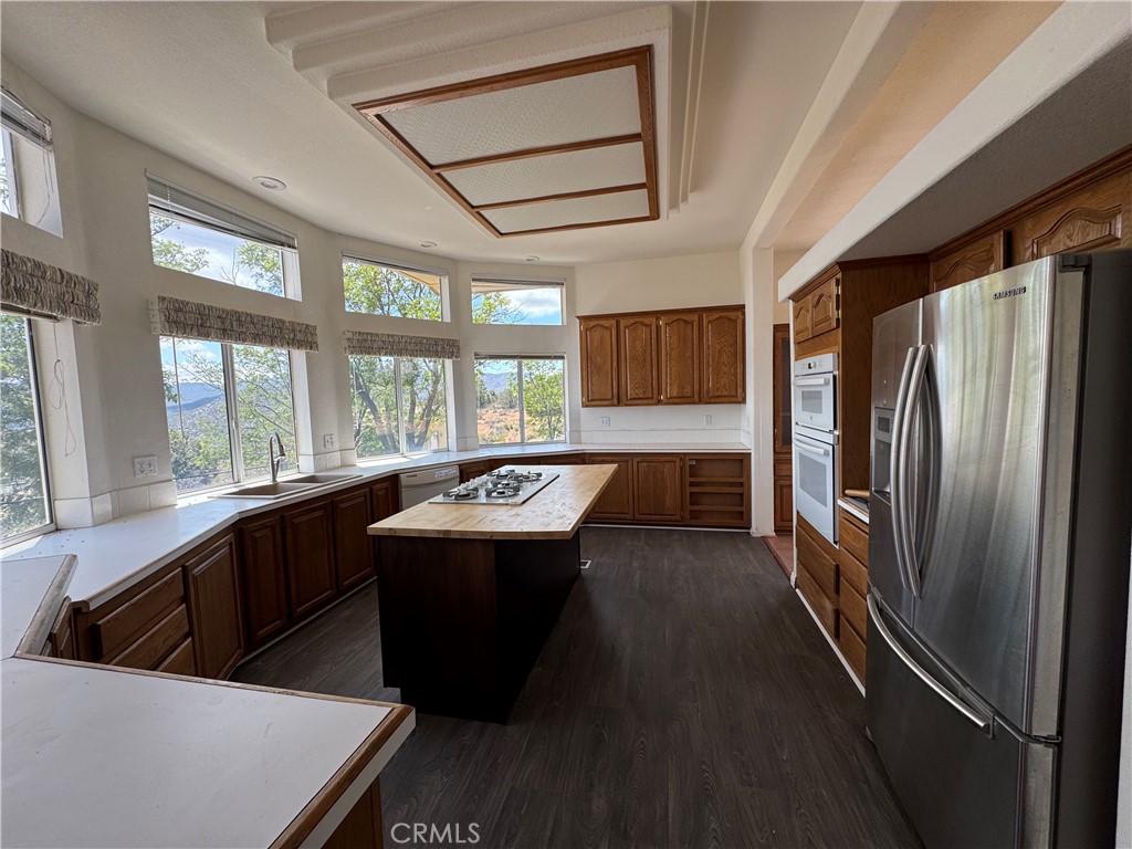 61225 High Country Trail Anza, CA 92539 - Photo 8 of 34 a kitchen with stainless steel appliances granite countertop a sink a stove and a refrigerator