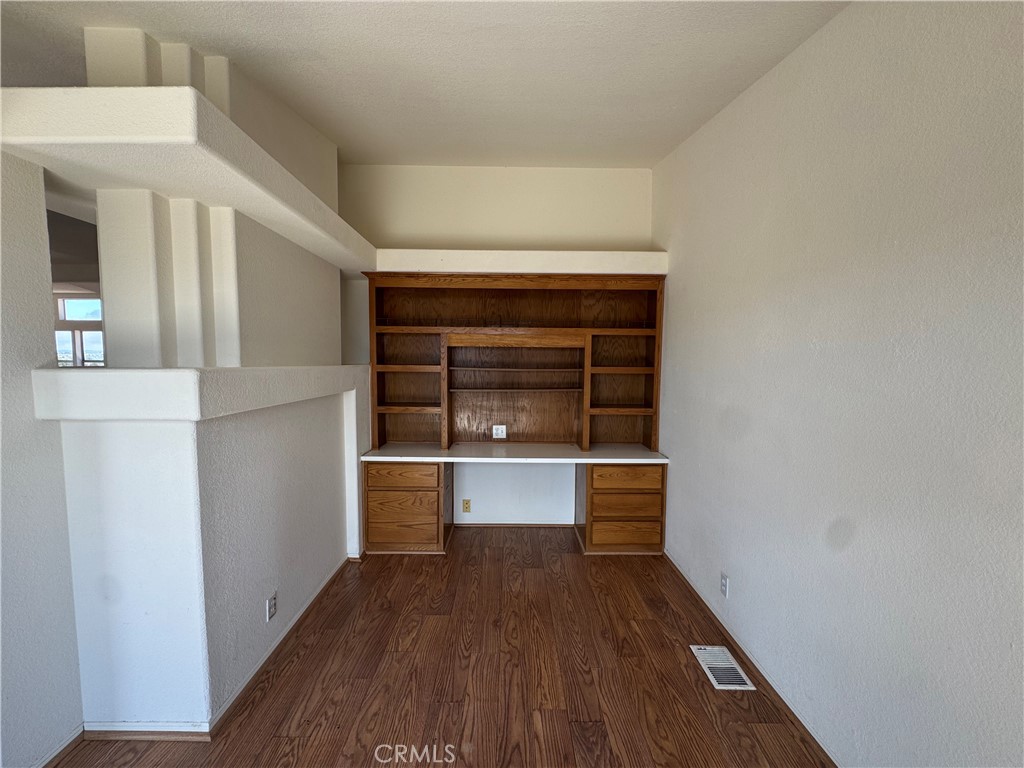 61225 High Country Trail Anza, CA 92539 - Photo 10 of 34 a hallway with wooden floor and staircase