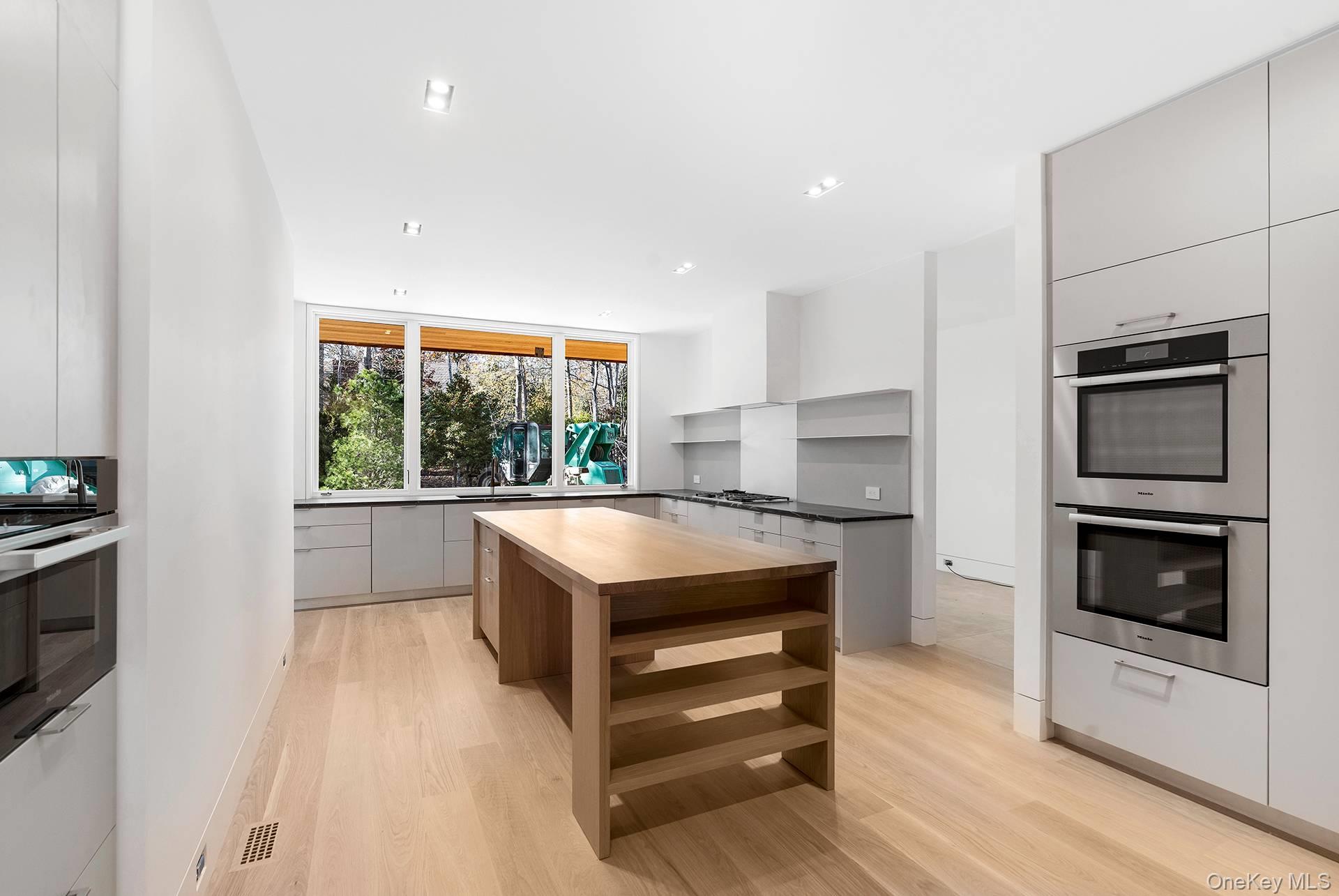 16 Arbor Path Amagansett, NY 11930 - Photo 4 of 10 a kitchen with stainless steel appliances a stove sink and microwave