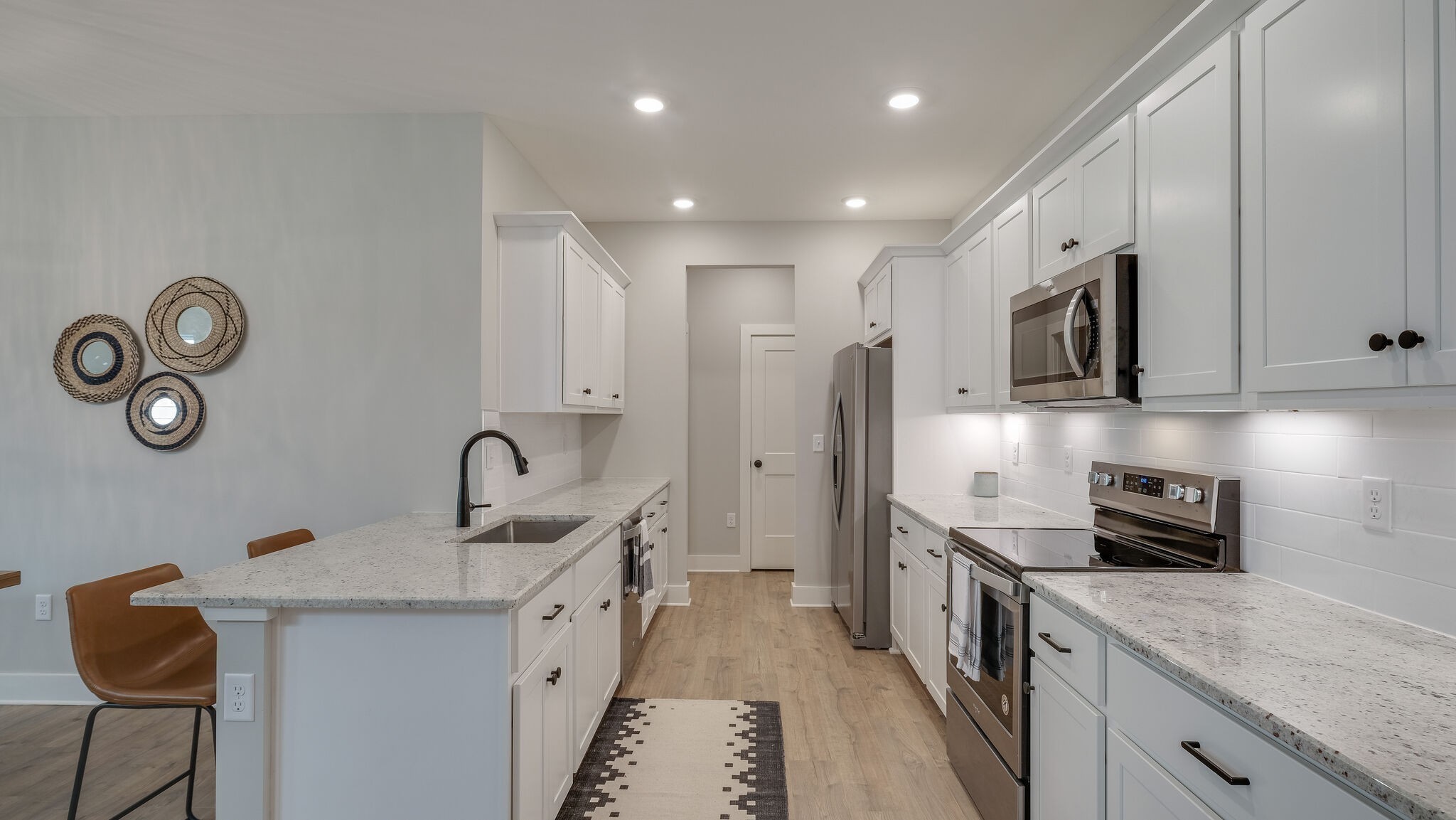 96 Camrose Way Murfreesboro, TN 37128 - Photo 7 of 22 a kitchen with stainless steel appliances granite countertop a sink a stove and a refrigerator