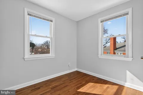 a view of room with window and wooden floor