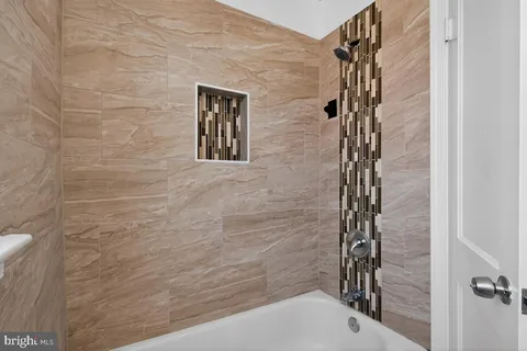 a bathroom with a shower and a tub