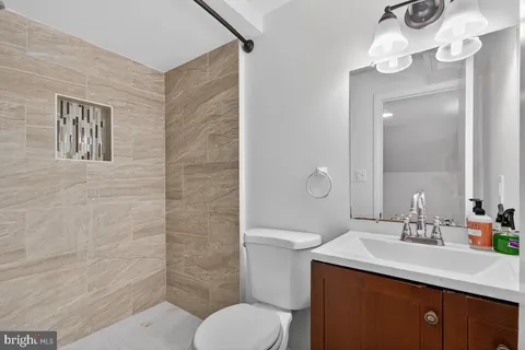 a bathroom with a sink toilet and shower