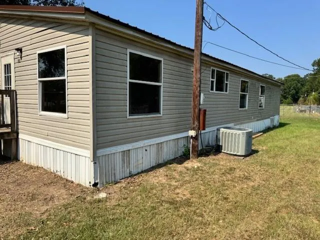 a view of a house with backyard and chair
