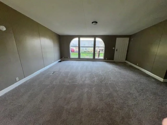 a view of empty room with a fireplace