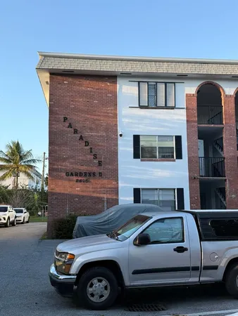 a front view of a house with parking space