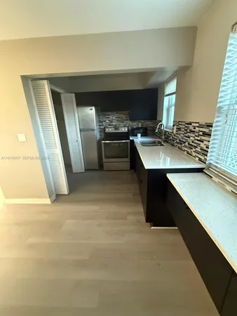 a view of a kitchen with a sink