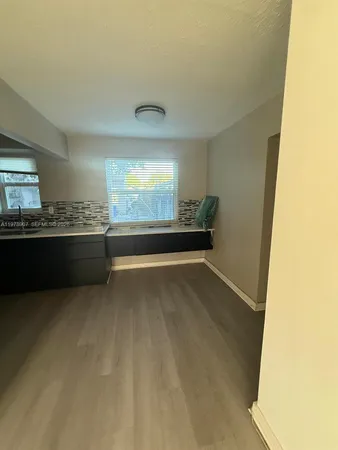 a view of a kitchen and a window